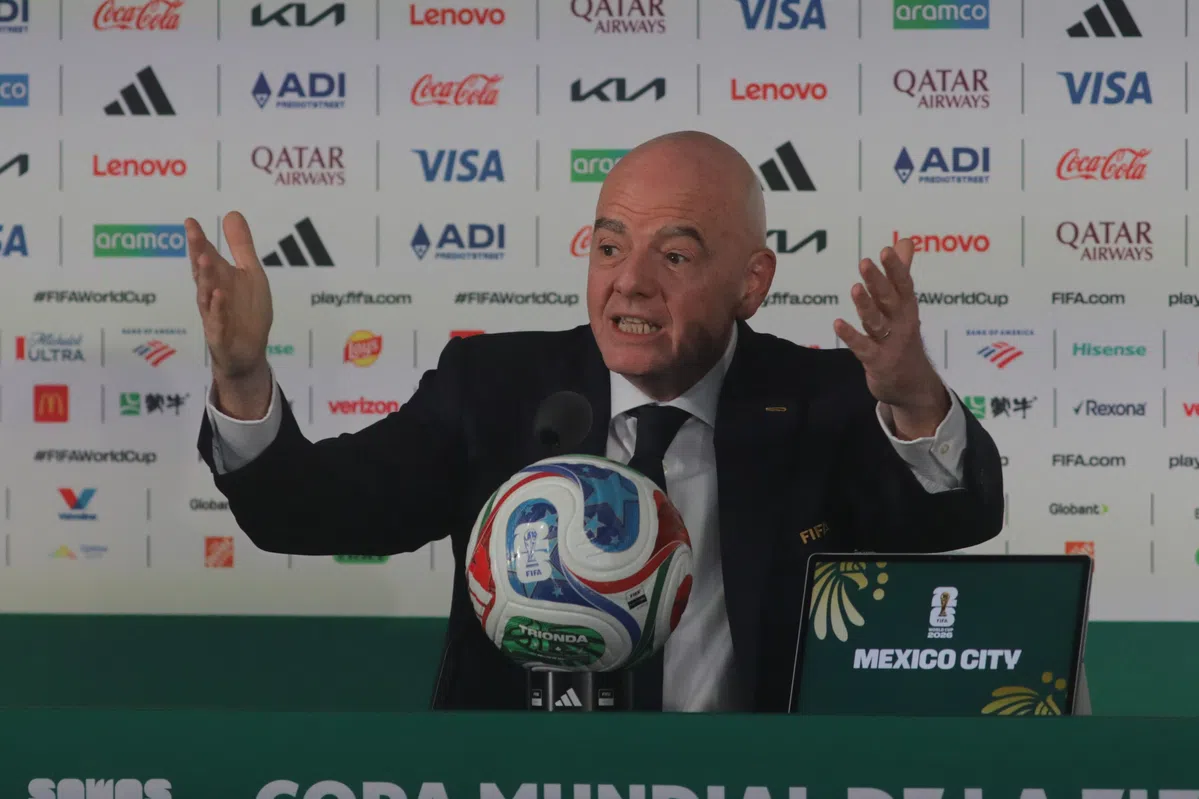 FIFA President Gianni Infantino gestures while speaking at a press conference.