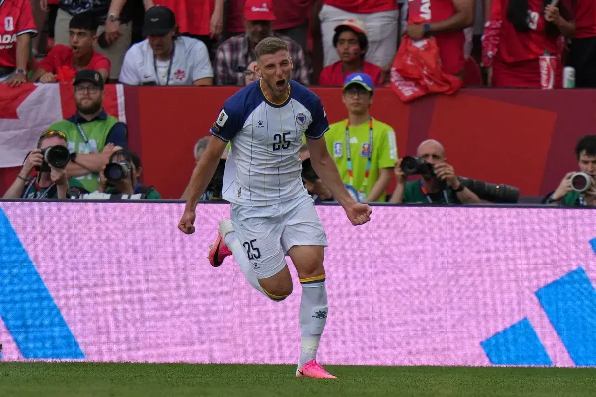 Jovo Lukic celebrates scoring a goal for Bosnia and Herzegovina during a World Cup match.