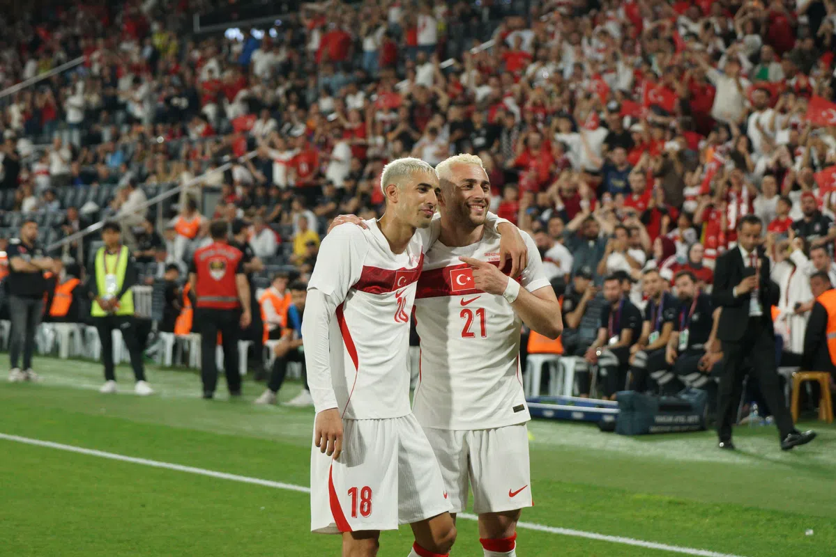 Players of the Turkish national football team celebrating on the field.