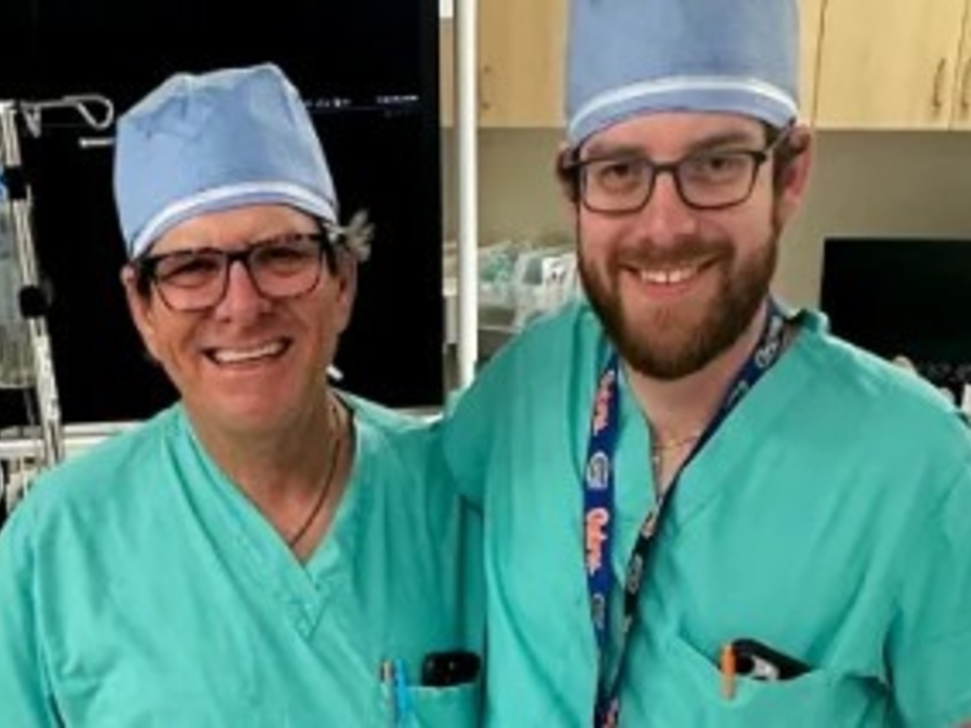 Dr. Joseph Wasselle Sr. and Dr. Joseph Wasselle Jr. posing in a surgical setting.