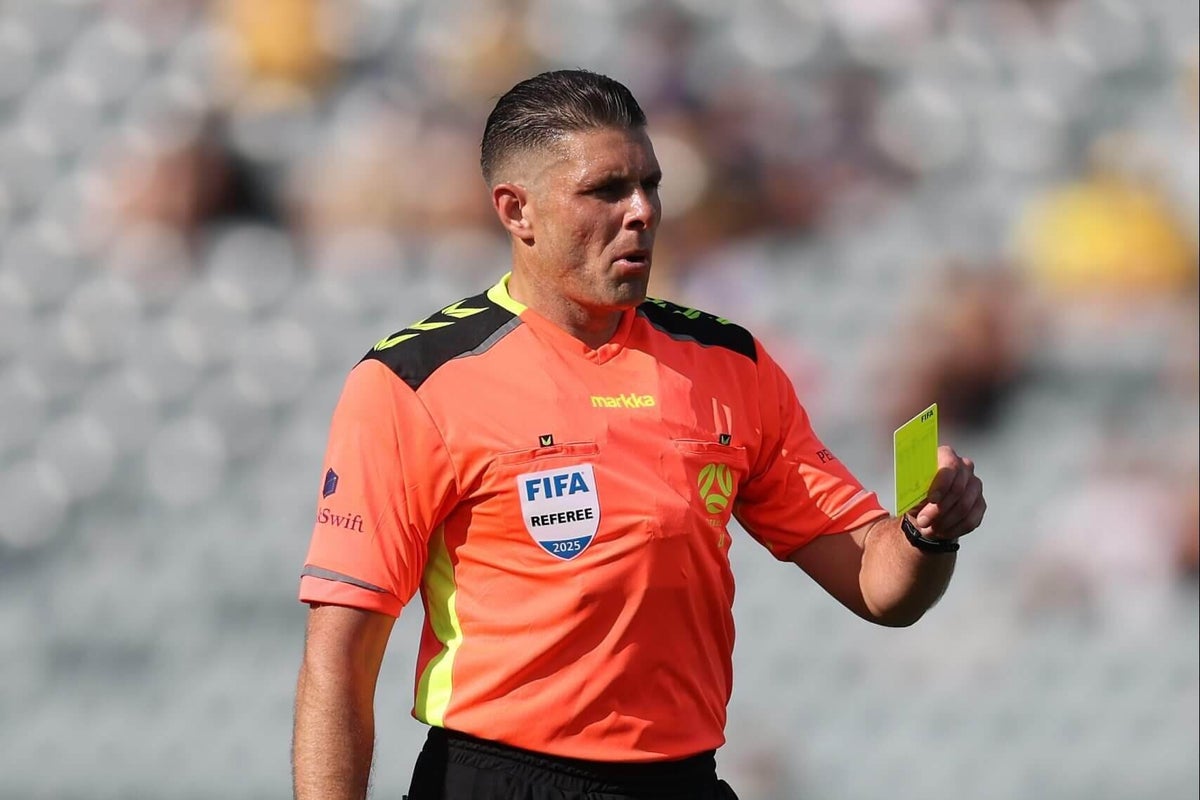 Referee Shaun Evans officiating a football match.