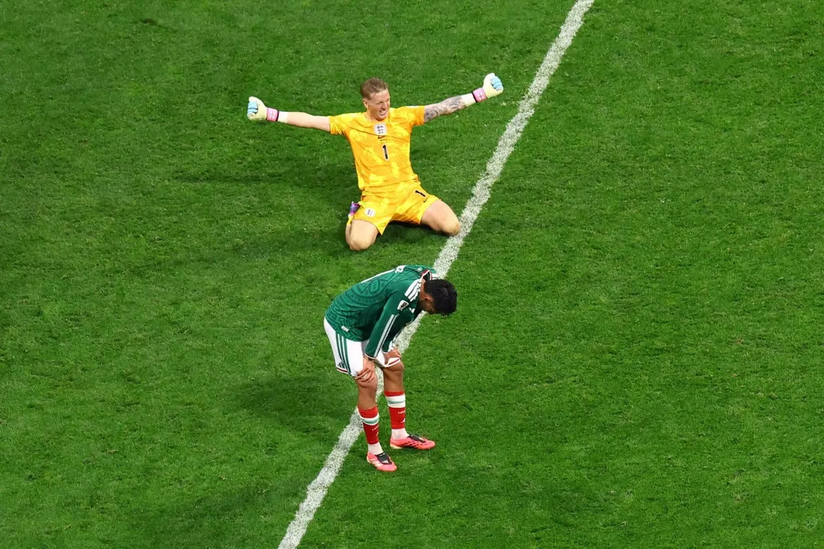 England players celebrating a goal during their World Cup match against Mexico.