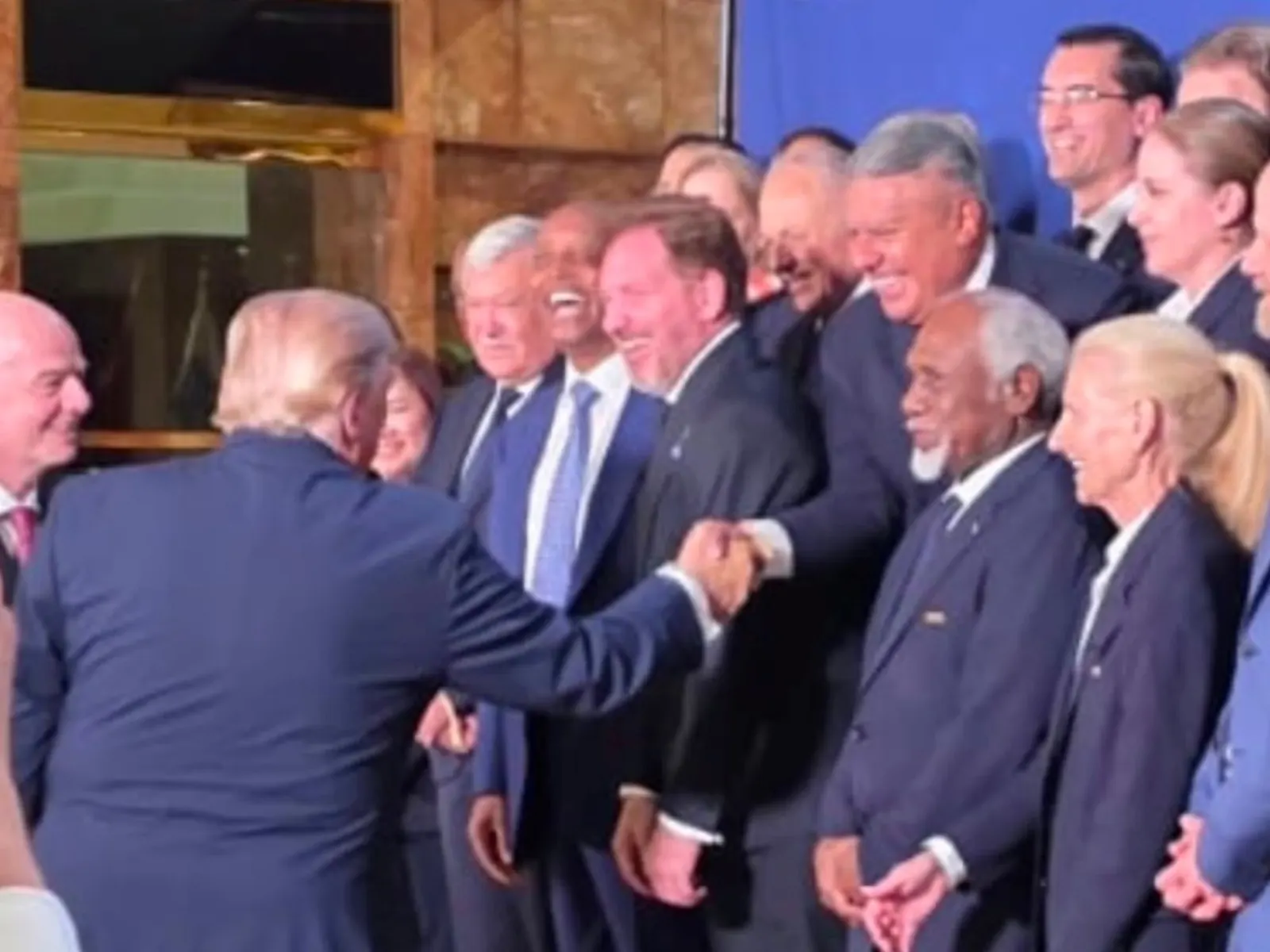 US President Donald Trump shakes hands with AFA President Claudio Tapia at a FIFA event.