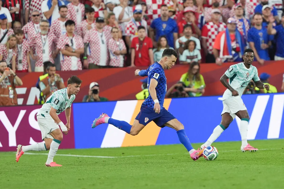 Ivan Perisic, wearing the Croatia national team jersey, celebrates scoring a goal.