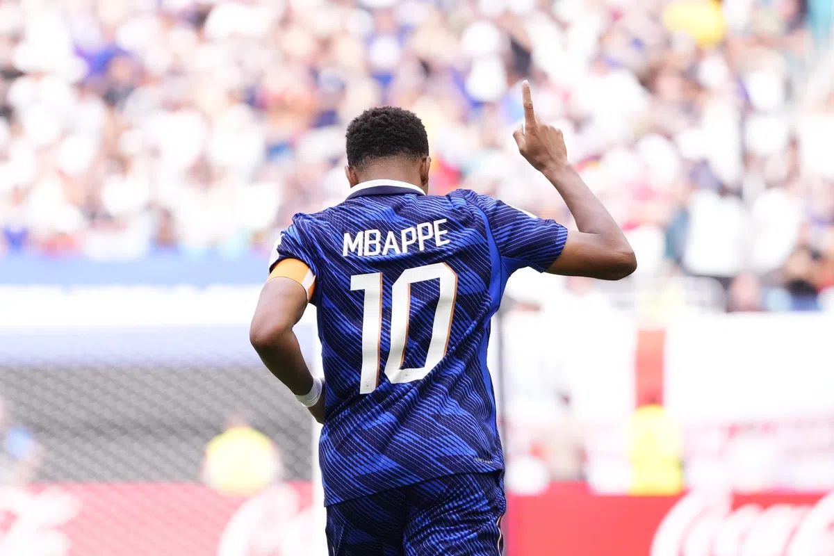 Kylian Mbappé celebrating a goal during a France national team match.