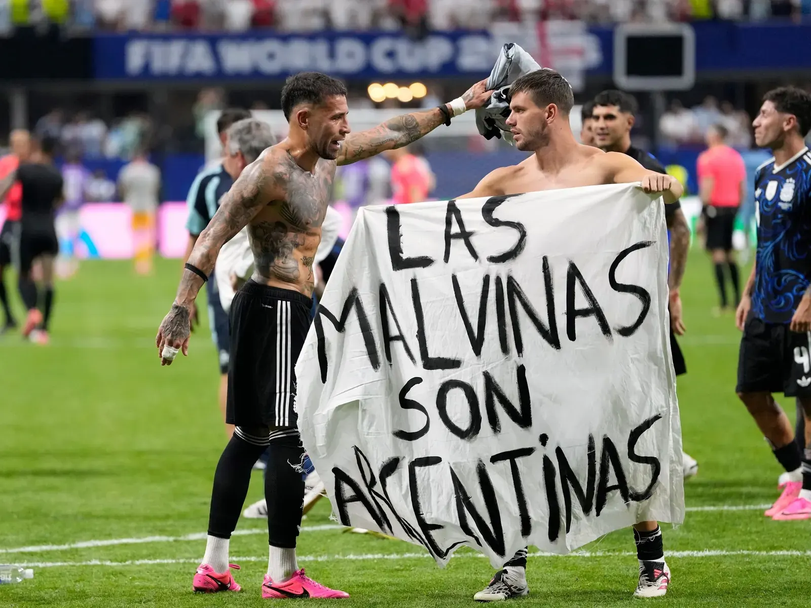 Argentina football players seen displaying a flag during a World Cup semi-final match.