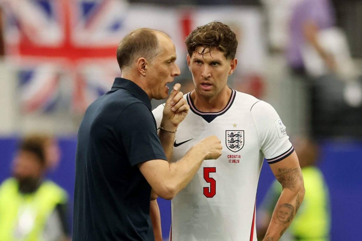 England manager Thomas Tuchel gestures while instructing players on the sidelines during a World Cup match.