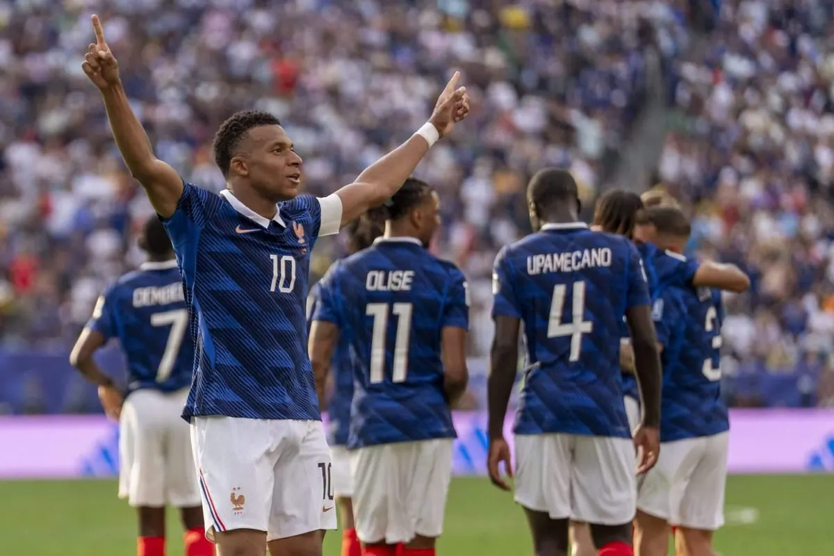 French football players celebrating a goal during a World Cup match.