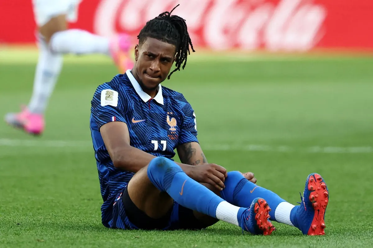 France's Michael Olise in action during a World Cup game, wearing football boots.