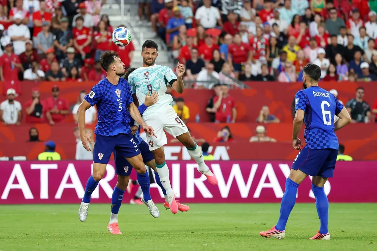 A jubilant football player celebrates scoring a late goal during a FIFA World Cup match.