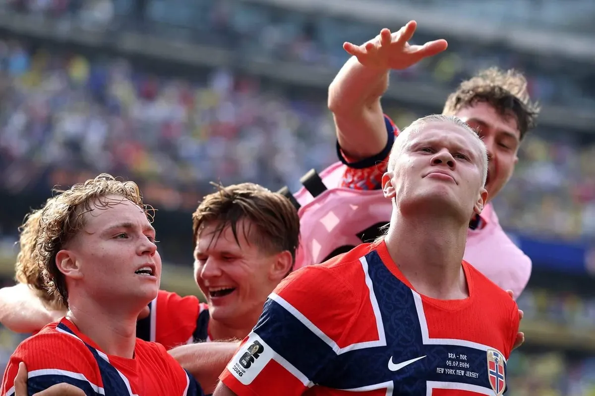 Erling Haaland celebrating with teammates after scoring a goal at the World Cup.