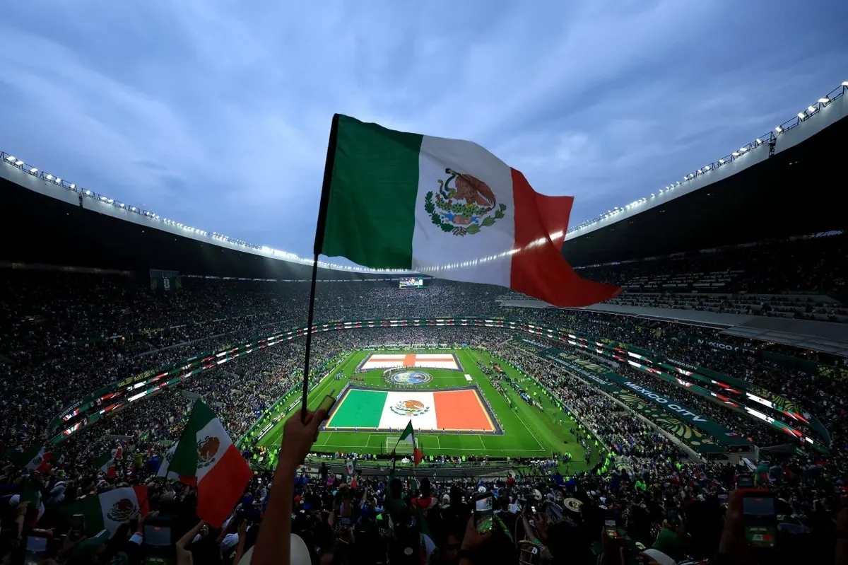 Mexico fans enthusiastically supporting their team at the Estadio Azteca during a World Cup match.