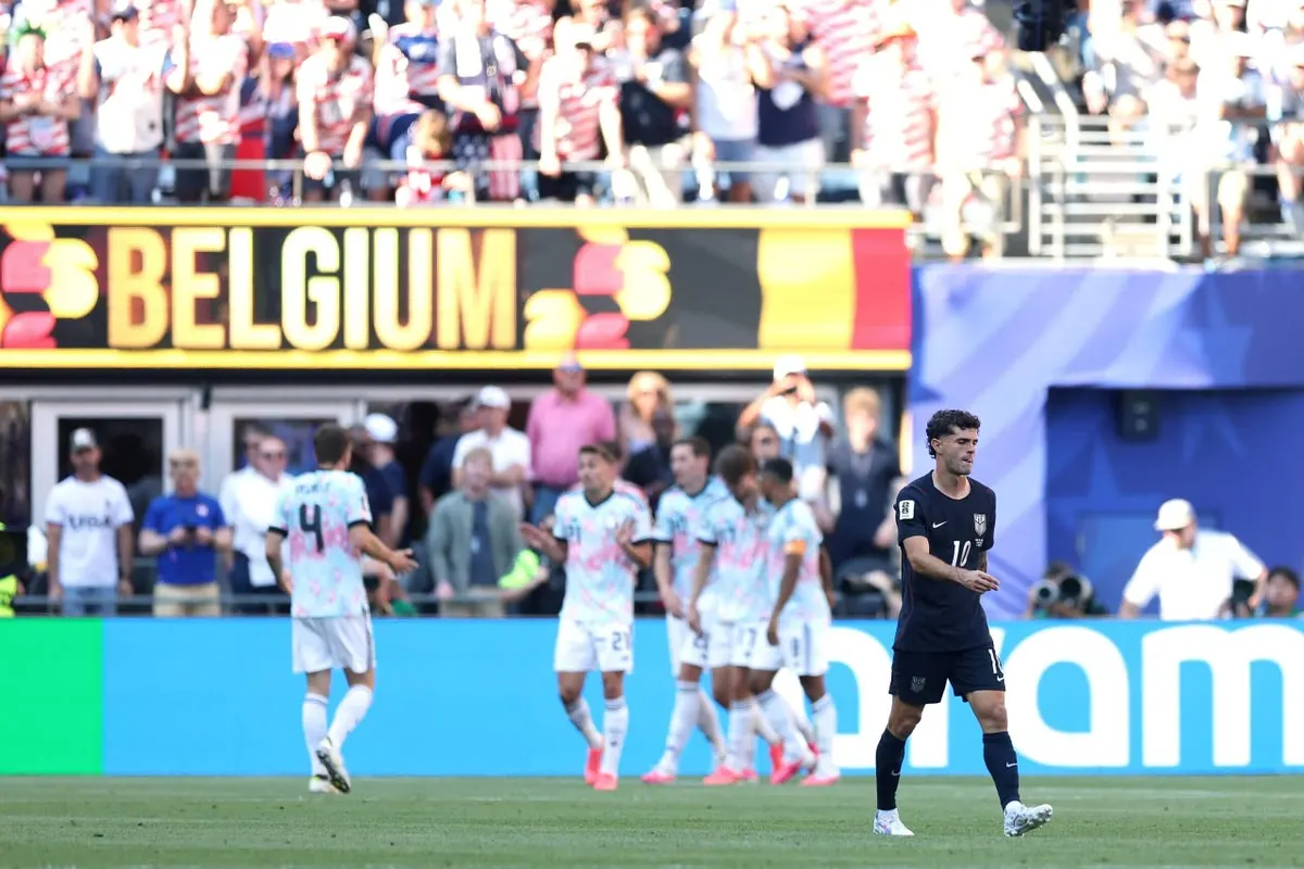 USMNT players look dejected on the field during their World Cup match against Belgium.