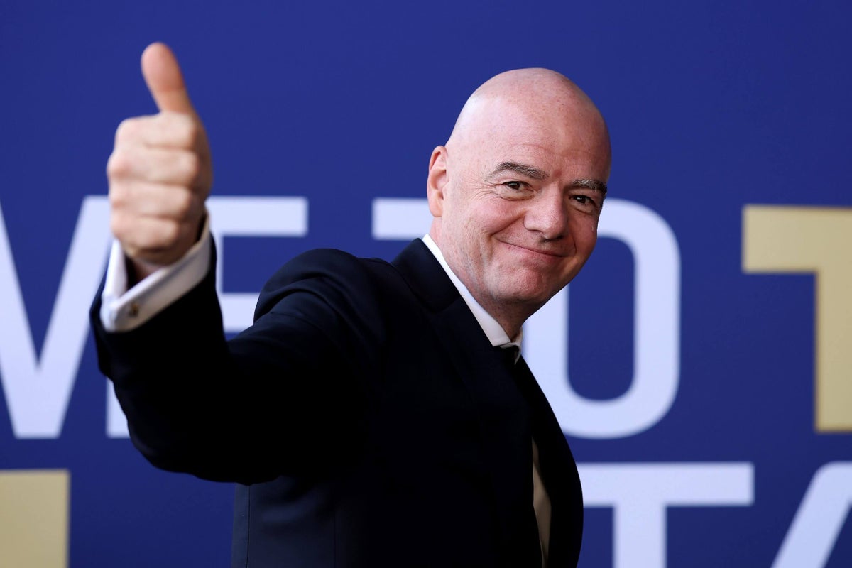 FIFA president Gianni Infantino speaking at a podium with World Cup branding behind him
