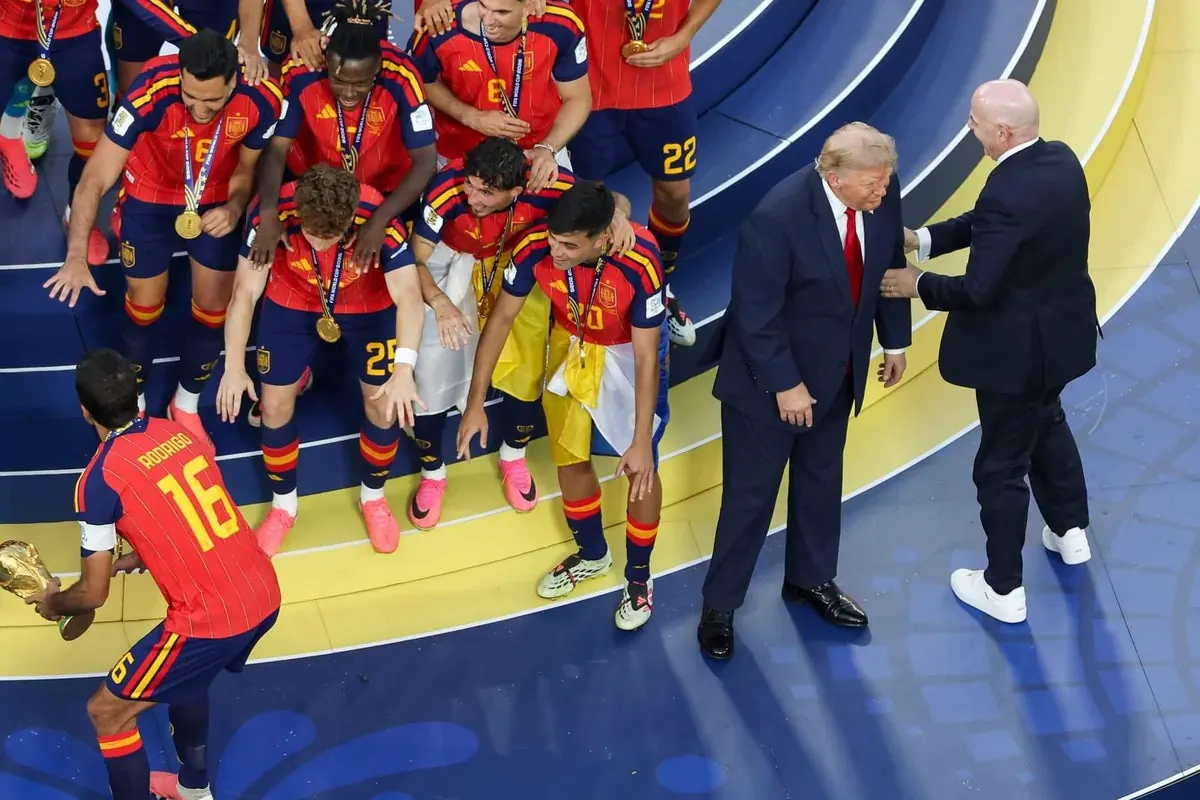 Donald Trump and Gianni Infantino on the pitch during the 2026 FIFA World Cup trophy presentation with Spain's players.