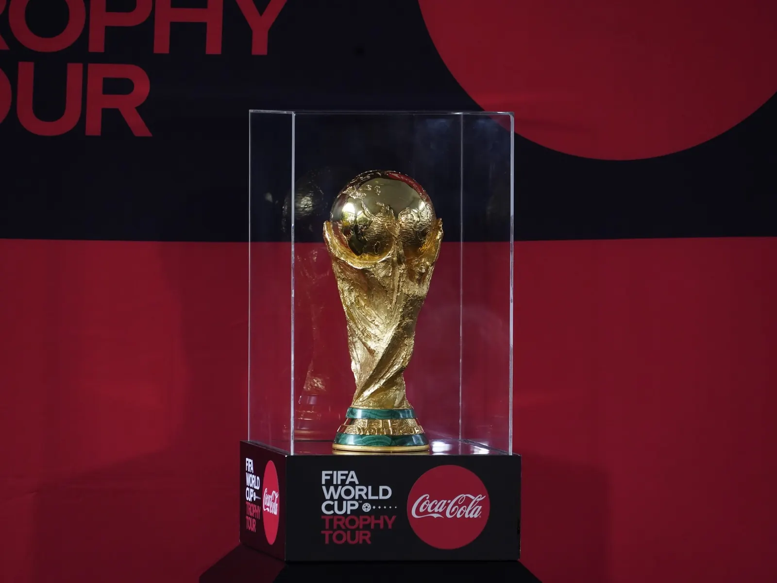 The FIFA World Cup trophy is displayed prominently, with confetti falling and graphics indicating prize money.