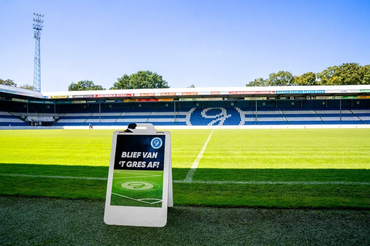 A wide shot of a Dutch football stadium, likely from the Keuken Kampioen Divisie, with empty stands.