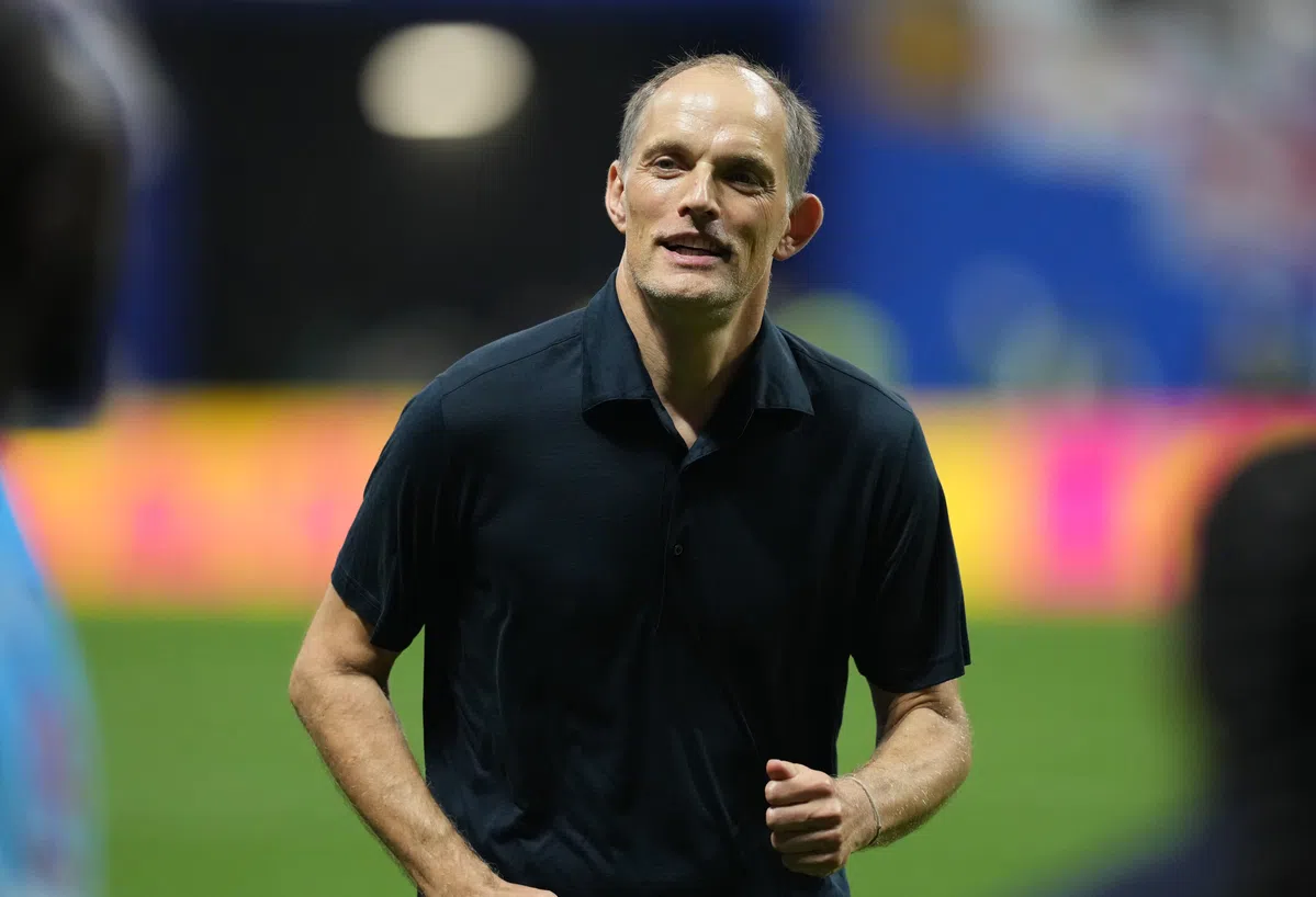England manager Thomas Tuchel speaking at a press conference, with text overlay about his World Cup appeal to parents.