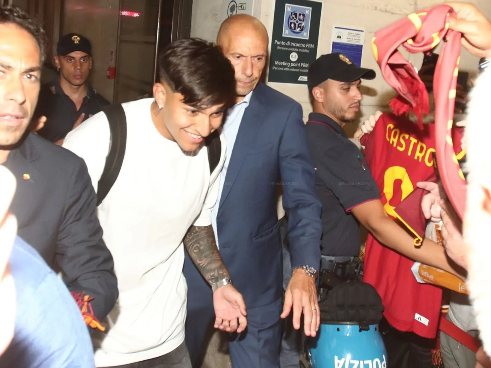 Santiago Castro holding an AS Roma scarf as he is welcomed by fans at Rome airport