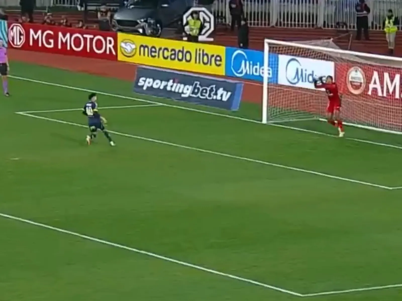 Tomás Aranda of Boca Juniors misses a panenka penalty against O'Higgins goalkeeper Omar Carabalí during the Copa Sudamericana shootout