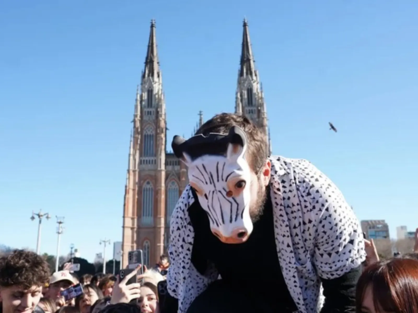 A large group of teenagers gathered at Plaza Moreno in La Plata for an aura farming competition on a sunny winter afternoon.